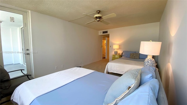 bedroom with ceiling fan and a textured ceiling