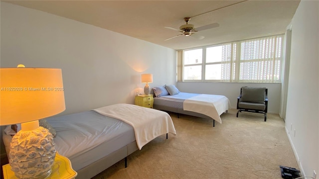 bedroom featuring ceiling fan and light colored carpet