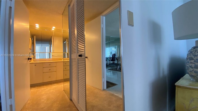 hallway with light colored carpet