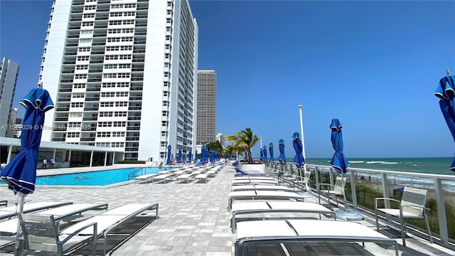 view of swimming pool featuring a water view