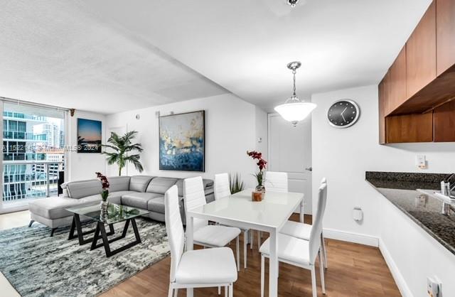 dining area with floor to ceiling windows and light wood-type flooring