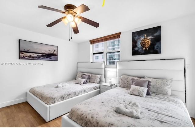 bedroom featuring light hardwood / wood-style floors and ceiling fan