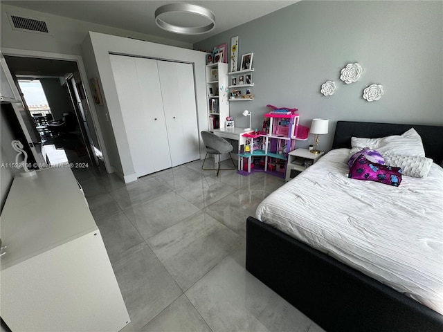 tiled bedroom featuring a closet