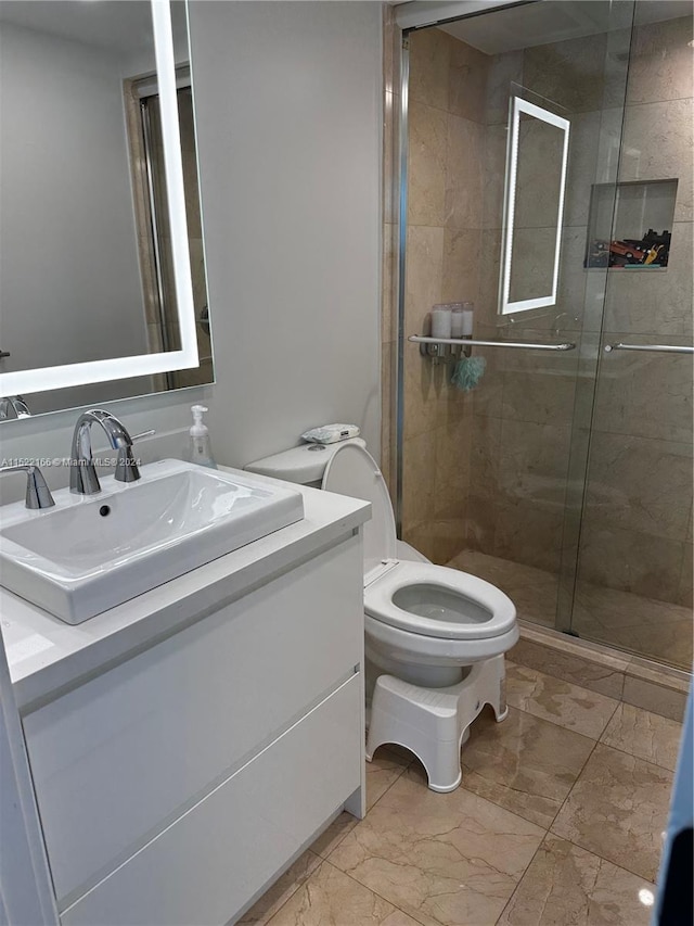 bathroom featuring toilet, a shower with door, tile floors, and oversized vanity