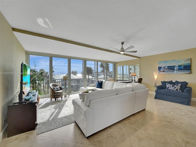 tiled living room with ceiling fan and plenty of natural light