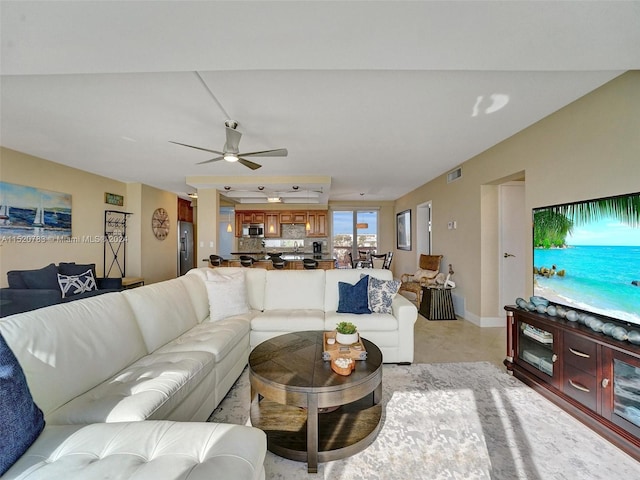 tiled living room with ceiling fan