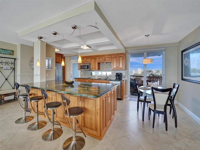 kitchen with tasteful backsplash, dark stone countertops, coffered ceiling, dishwasher, and fridge