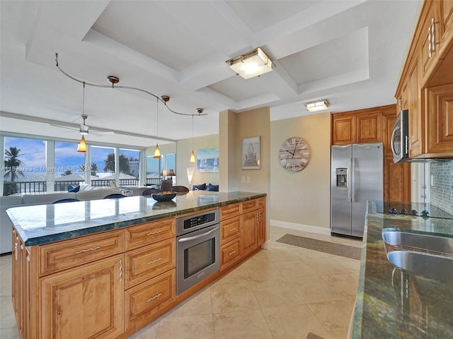 kitchen featuring pendant lighting, wall oven, refrigerator, light tile patterned flooring, and a center island