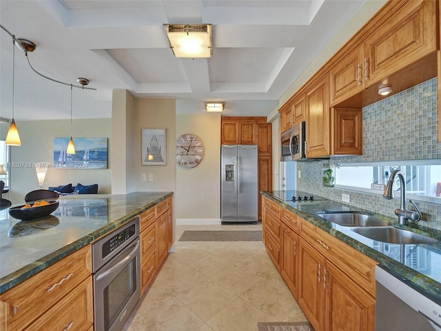 kitchen featuring tasteful backsplash, stainless steel appliances, sink, dark stone countertops, and a raised ceiling