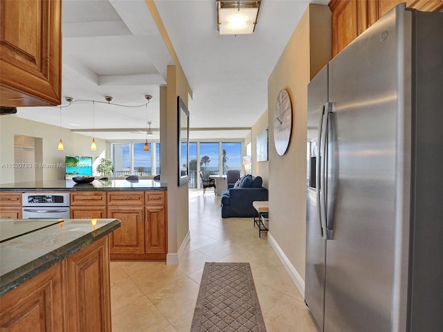 kitchen with decorative light fixtures, appliances with stainless steel finishes, and light tile patterned floors