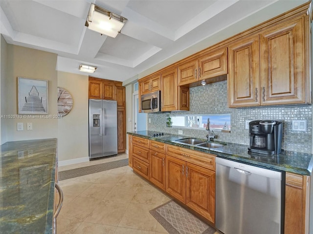 kitchen featuring tasteful backsplash, stainless steel appliances, sink, dark stone countertops, and light tile patterned floors