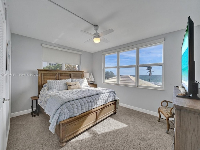 bedroom featuring light colored carpet and ceiling fan