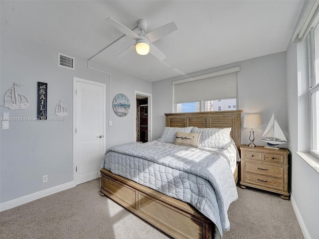 carpeted bedroom with a closet and ceiling fan