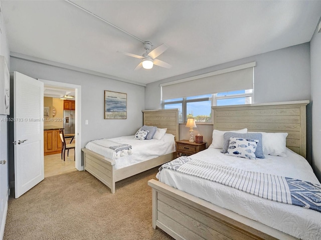 carpeted bedroom with stainless steel fridge and ceiling fan