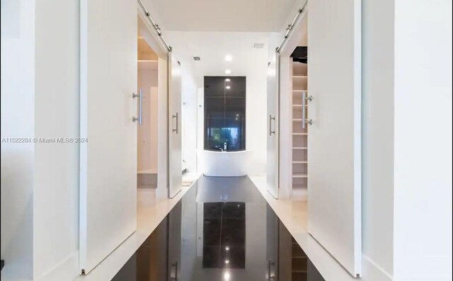 interior space with a barn door and recessed lighting