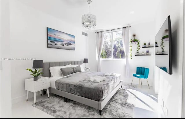 bedroom with a notable chandelier