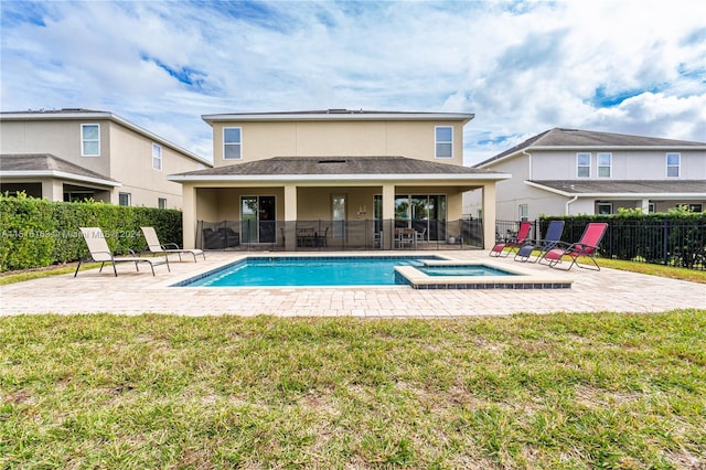 view of swimming pool featuring a patio area, an in ground hot tub, and a yard