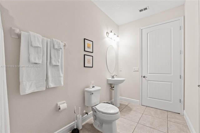 bathroom featuring tile patterned flooring and toilet