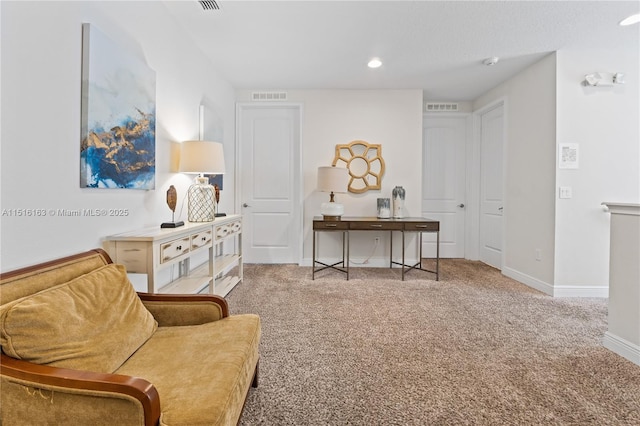 living area featuring light colored carpet