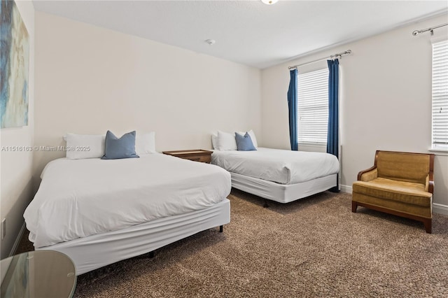 carpeted bedroom featuring multiple windows