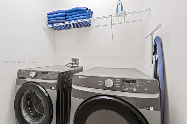 clothes washing area featuring washing machine and dryer