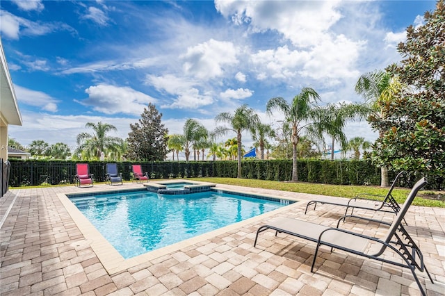 view of swimming pool with an in ground hot tub and a patio area