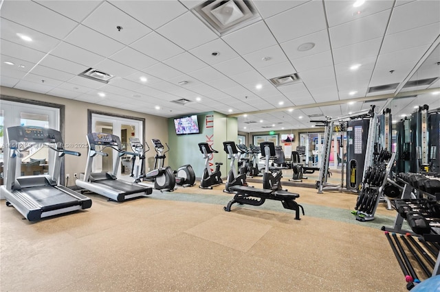 exercise room featuring a drop ceiling and french doors