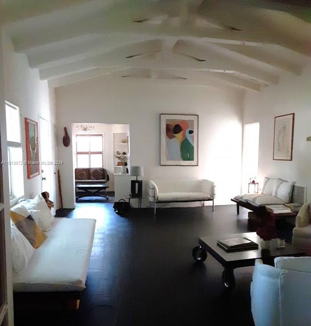 living room featuring hardwood / wood-style flooring and lofted ceiling with beams