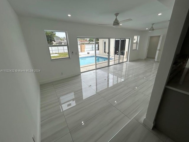 unfurnished room featuring light tile floors and ceiling fan