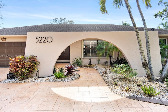 doorway to property with a garage