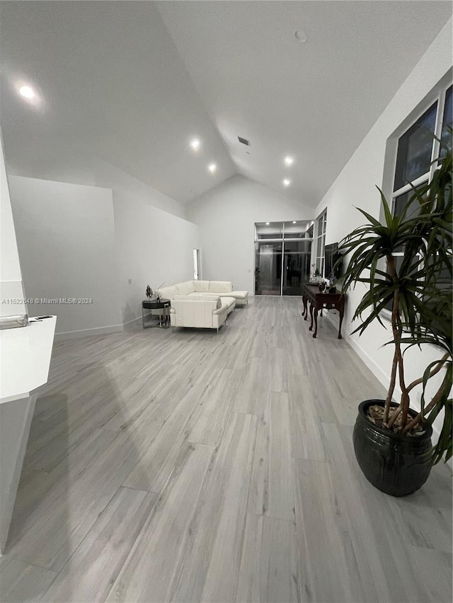 bedroom featuring vaulted ceiling and light wood-type flooring