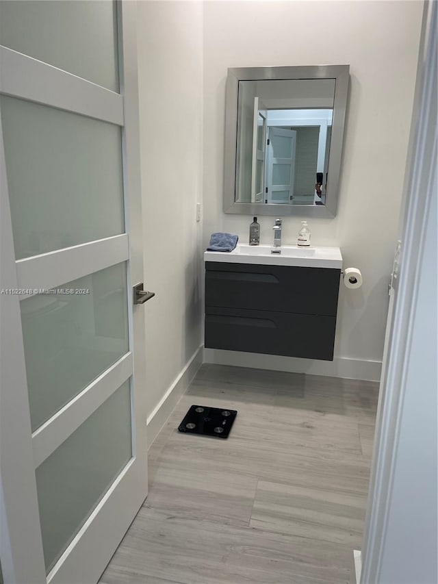 bathroom with oversized vanity and hardwood / wood-style flooring