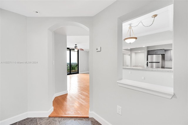 corridor with hardwood / wood-style flooring and sink