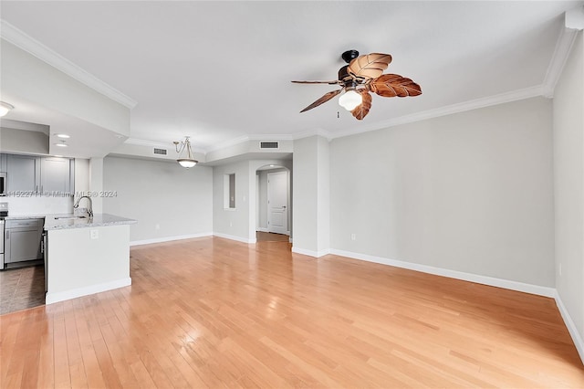 unfurnished living room with light hardwood / wood-style floors, ceiling fan, crown molding, and sink