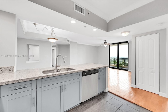 kitchen featuring ceiling fan, sink, dishwasher, decorative light fixtures, and light wood-type flooring