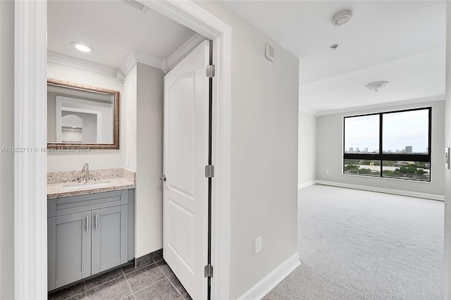 bathroom with vanity and ornamental molding