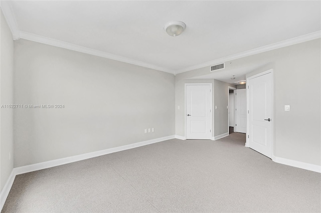 carpeted spare room with crown molding