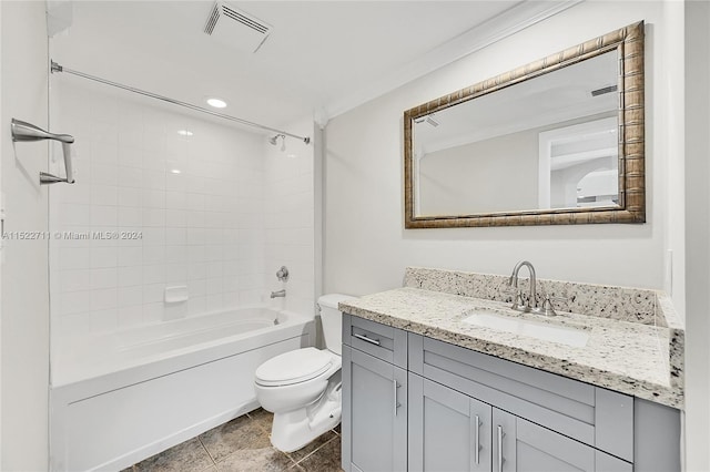 full bathroom featuring tiled shower / bath combo, tile patterned floors, toilet, vanity, and ornamental molding