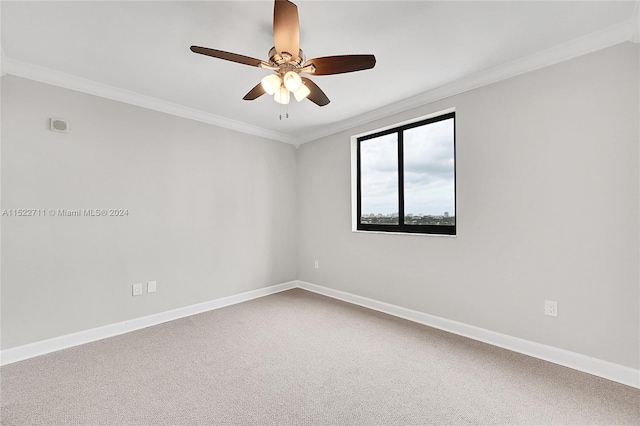 carpeted empty room with ceiling fan and crown molding