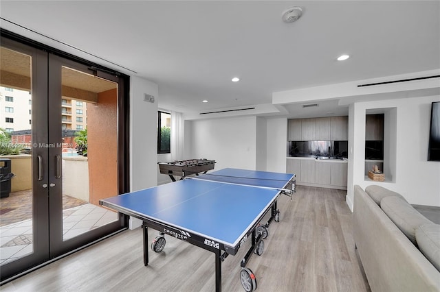 recreation room with light hardwood / wood-style flooring