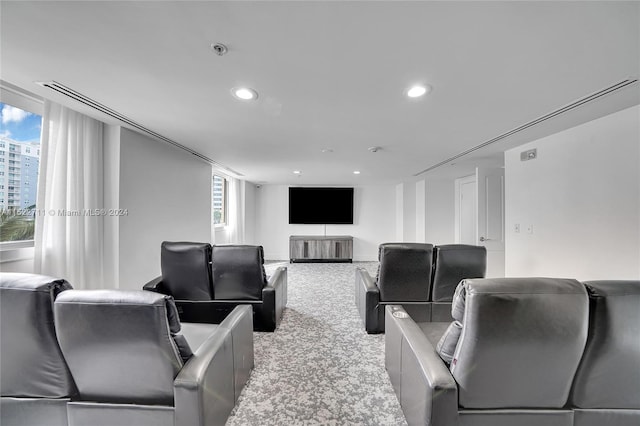 home theater featuring light colored carpet and a wealth of natural light