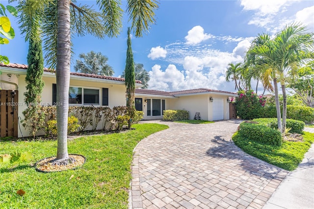 view of front of house with a front yard and a garage