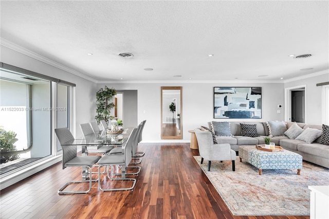 living room with a textured ceiling, dark wood-type flooring, and ornamental molding