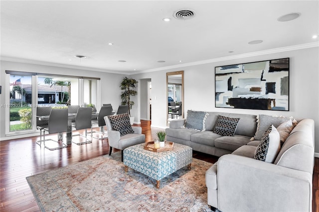 living room with hardwood / wood-style flooring and crown molding