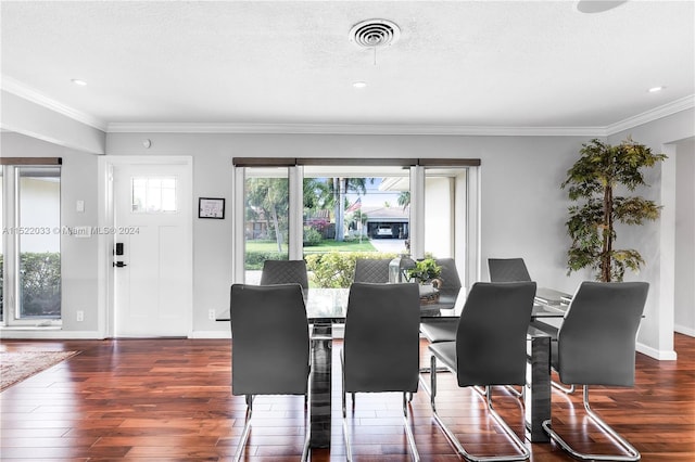 dining space with crown molding and dark hardwood / wood-style flooring