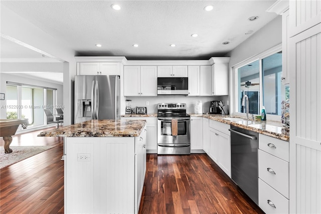 kitchen featuring dark hardwood / wood-style floors, sink, white cabinets, stainless steel appliances, and stone countertops