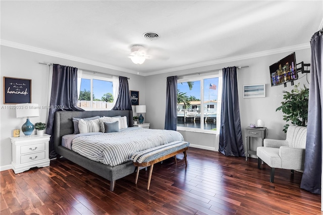 bedroom with crown molding, dark hardwood / wood-style flooring, and ceiling fan