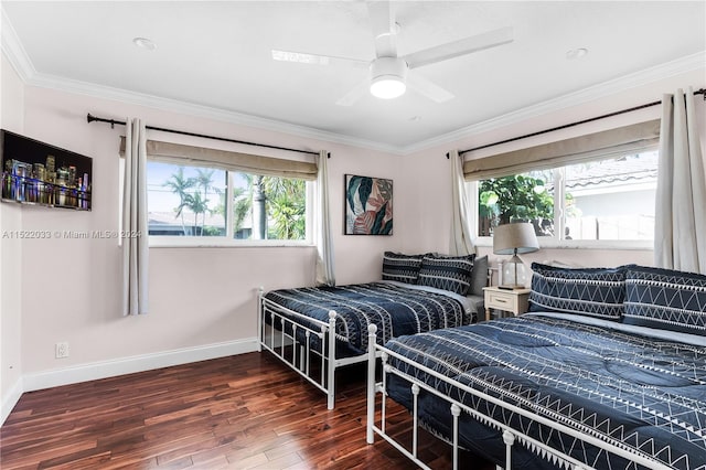 bedroom with ceiling fan, multiple windows, dark wood-type flooring, and ornamental molding