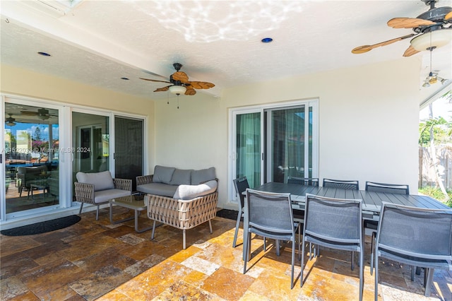 view of terrace with an outdoor living space and ceiling fan