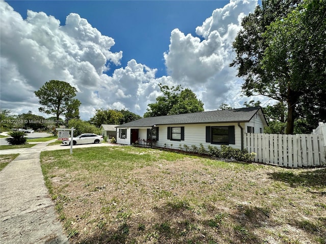 rear view of property with a lawn